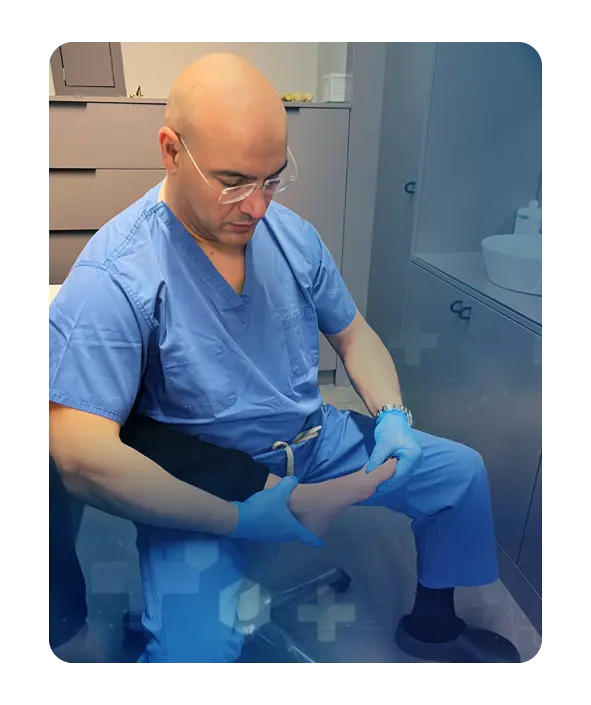 Semih Ayanoglu examining a patient's left foot